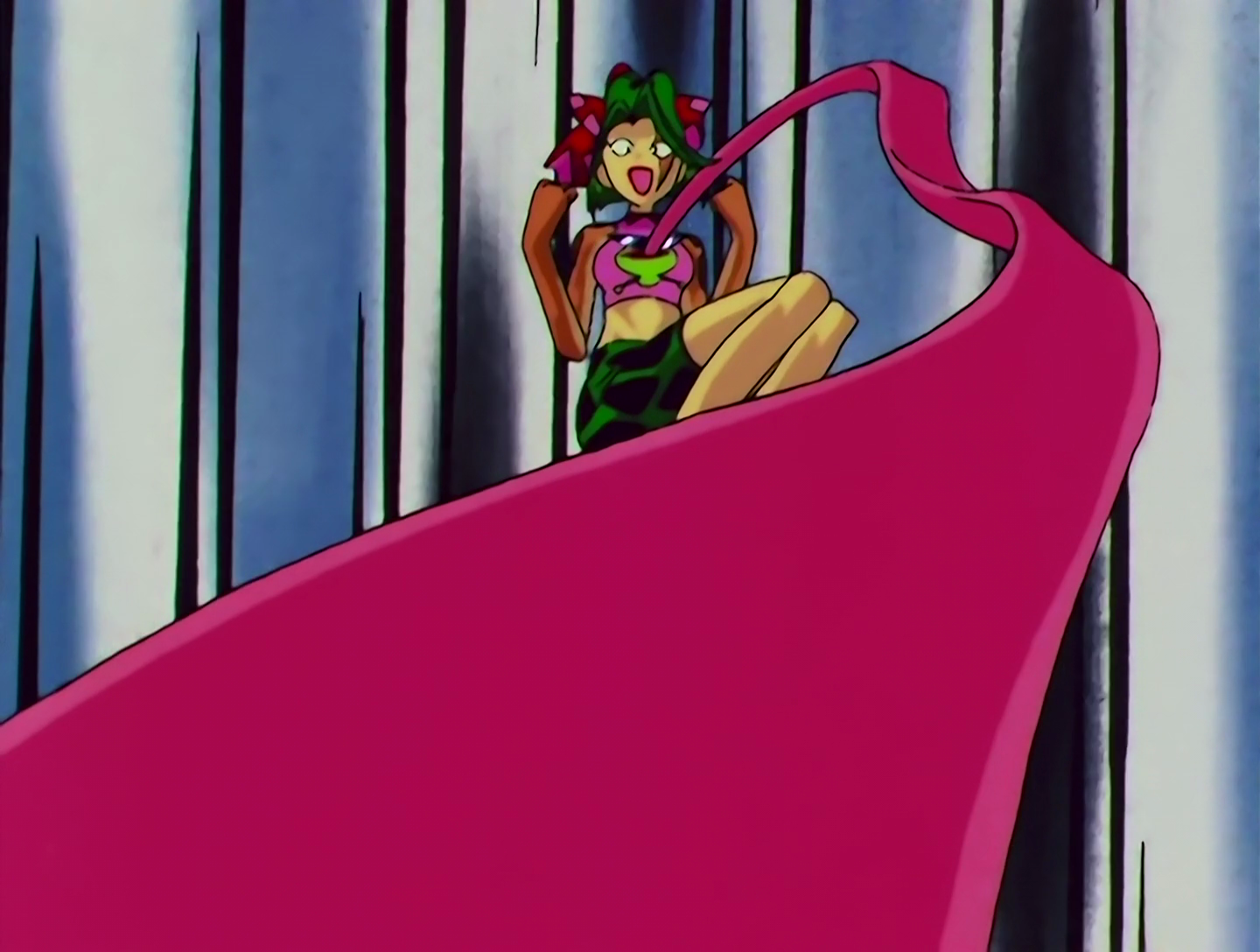 KeroKero Musume has now achieved her true form, a yellow skinned, green haired frog lady. She wears green and black shorts, long orange gloves with webbed fingers, and a pink shirt with a frog face on it. A very long tongue is extending from the frog’s mouth.